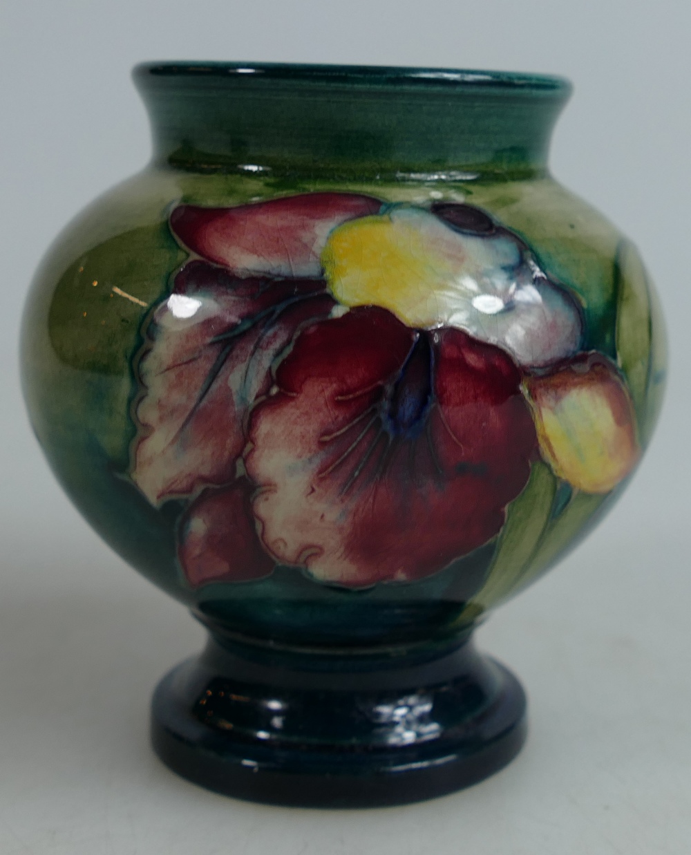 Moorcroft small vase decorated in the Orchid design, height 9cm.