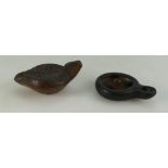 Two small ancient clay lamps, believed to be of Greek or Roman origin.