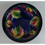 Moorcroft footed dish decorated in the Leaf & Berries design, diameter 17cm.