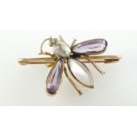 Yellow metal dragonfly pendant set with amethyst and semi precious stones, 7.3 grams.