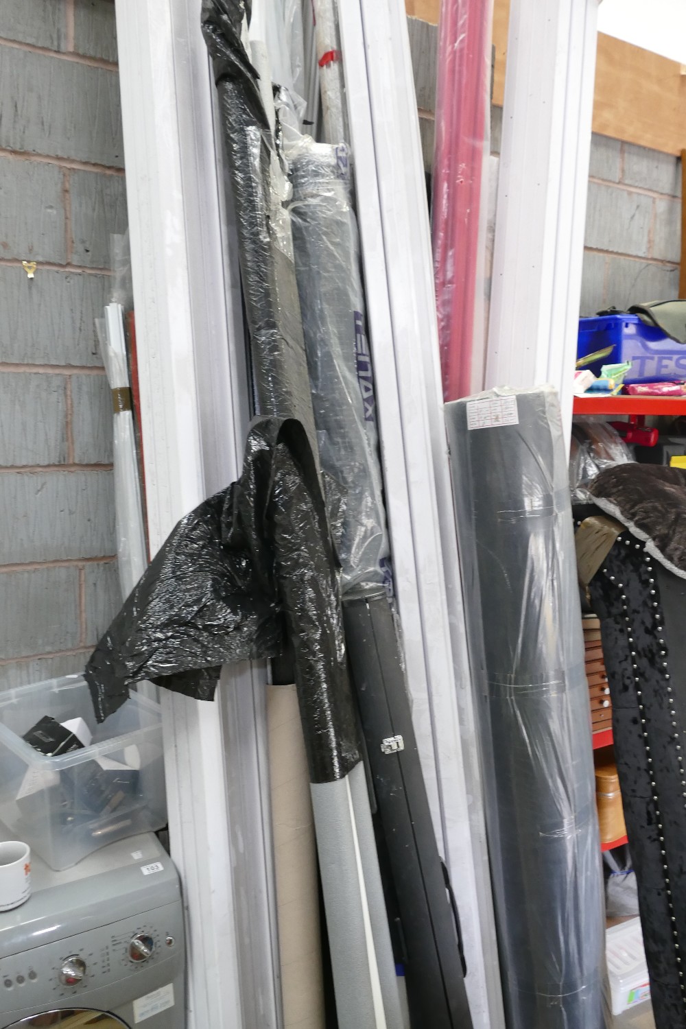A large selection of lengthy items to include metal poles, plastic electrical skirting,
