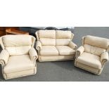 Three piece leather suite comprising of two armchairs and a two seater sofa in cream leather