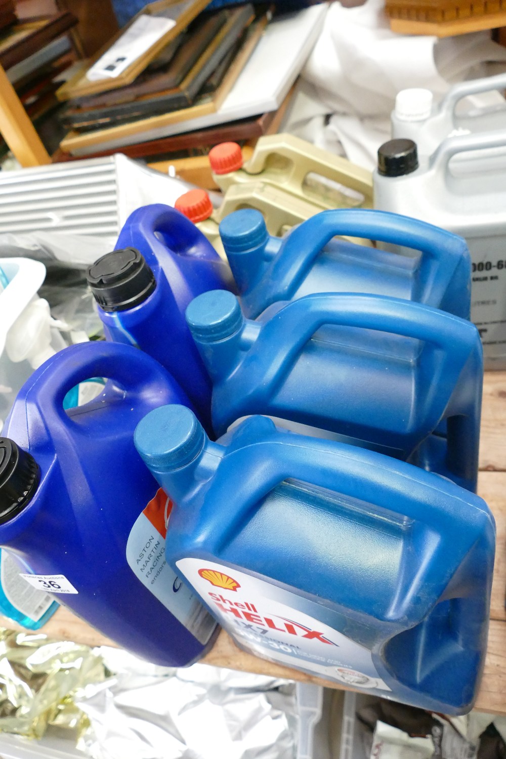 A selection of motor oils to include Shell Helix professional motor oil, Castrol Racing Oil,