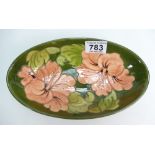 Moorcroft Hibiscus on green g round footed oval bowl,