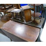 A 20th century mahogany drop leaf table, an oak glazed fronted smokers cabinet,