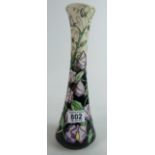 Moorcroft vase, decorated with lavender and yellow flowers, on a cream and black ground,