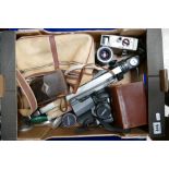 A mixed collection of vintage camera equipment including Minnolta X500 film camera,