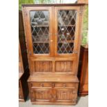 Twentieth century oak linenfold old charm style unit with two over two base below and drop down