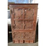 An early Oak panelled housekeepers cupboard with a single door above two smaller drawers and inlay