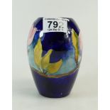 Moorcroft pink Magnolia vase on blue ground.