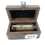 A brass marine telescope in wooden case