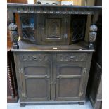 Twentieth century dark oak two over two court cupboard with canted top and leaded glazed sides