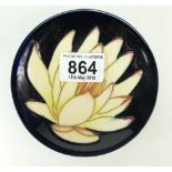 Moorcroft coaster decorated with a yellow water lily design,