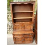 Twentieth century oak linenfold old charm style unit with two over two base below a two door