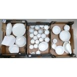 A large collection of undecorated dinnerware to include cups,