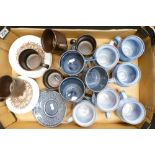 A collection of studio pottery in pale blue, drinking mugs marked A.J.