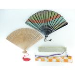 Two Oriental fans - one Japanese silk fan and a Chinese bamboo fan.