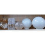 A collection of mid century glass lamp shades and light fittings .