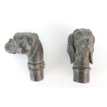 Two bronze walking stick tops fashioned as dogs heads