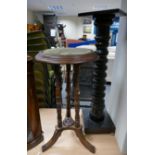 An oak tripod circular topped occasional table with turned column support and velour top with