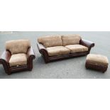 A large settee in antique leather and fabric upholstered back and cushions,