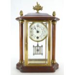 Mahogany and brass mantle clock with bevelled glass panels. Movement trips through when wound.