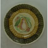 A Susie Cooper Crown Works charger decorated in various colours with a pear,