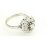 Diamond cluster ring set in white metal (tested as 18ct gold), size N, 5.3 grams.