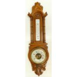 Carved Oak framed Aneroid barometer (cracks to glass),