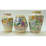 A collection of floral decorated Poole Pottery vases (height of tallest 25cm) (3)