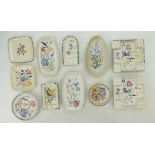 A collection of Poole Pottery floral decorated flatware to include ash trays,