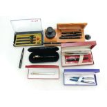 A collection of vintage fountain pens including Waterman, Sheaffer,