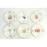 A collection of Minton gilded cabinet plates decorated with various fruits and signed by artists G