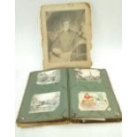 A leather album containg a large collection of vintage postcards, towns, villages,