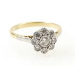 18ct gold and diamond set Daisy ring, central stone surrounded by 8 smaller stones, collet set.