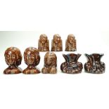 Group of 8 various treacle glazed 19th century pottery FURNITURE RESTS comprising 2 x 'paw' rests,