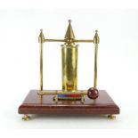Trench Art brass dinner gong on wooden base with Spearhead patch, 28cm.