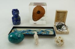 A collection of items including a Jade necklace, Ancient Byzantine oil lamp,