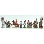 A collection of Michael Sutty hand painted sculpture military chess pieces (8)