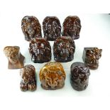 Group of 8 treacle glazed 19th century pottery FURNITURE RESTS modelled as a lions head,