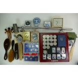 Tray containing quantity of old coin sets, QEII crowns, Zippo lighters, car badges, clock etc.