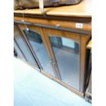 Modern glass fronted display cabinet with illumination and integral drawer to lid