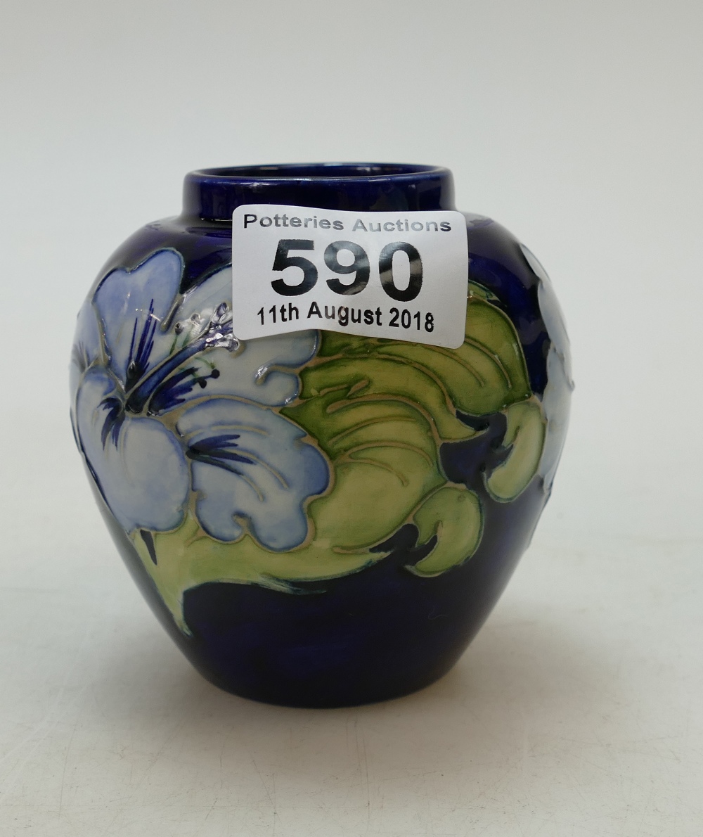 Unusual small Moorcroft Hibiscus on blue ground vase 10cm high.