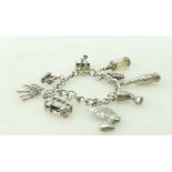 Silver charm bracelet containing 8 charms ,