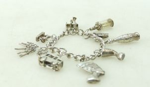 Silver charm bracelet containing 8 charms ,