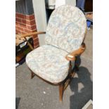 A mid-century elm Ercol Fleur de Lis arm chair