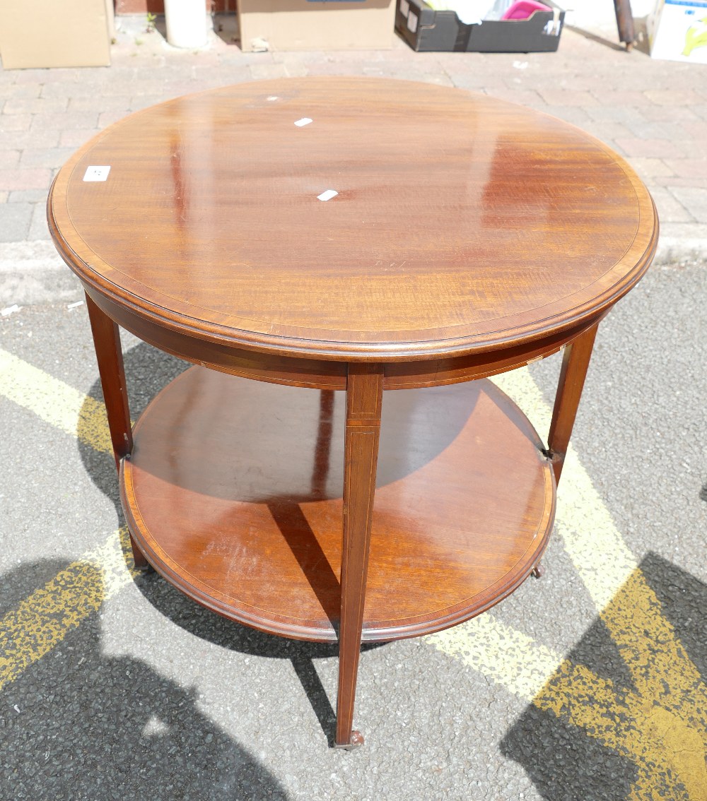 A Georgian style two tier side table on casters with inlay and crossbanding.