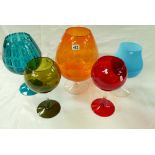 A collection of mid century and later oversized coloured glass vases in the form of drinking