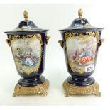 A pair of reproduction ornate gilt and cobalt blue Urns with renaissance decoration (2).