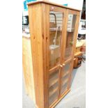 A modern pine glazed 2 door display cabinet